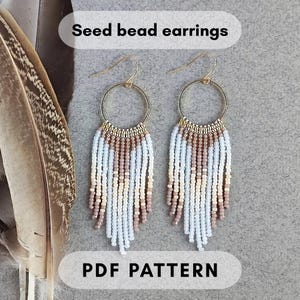 May include: Seed bead earrings with a fringe design. The earrings have gold-coloured hoops and are decorated with white, light blue, tan, and brown seed beads. The text "Seed bead earrings" and "PDF PATTERN" are displayed in the image.