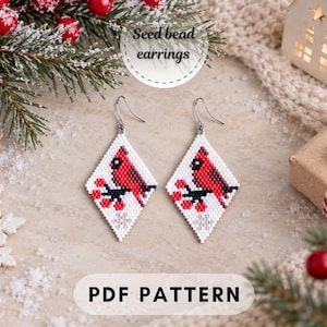 May include: Diamond-shaped seed bead earrings featuring a red cardinal bird perched on a branch with red berries against a white background. The image includes the text Seed bead earrings and PDF PATTERN, showcasing a festive holiday design.