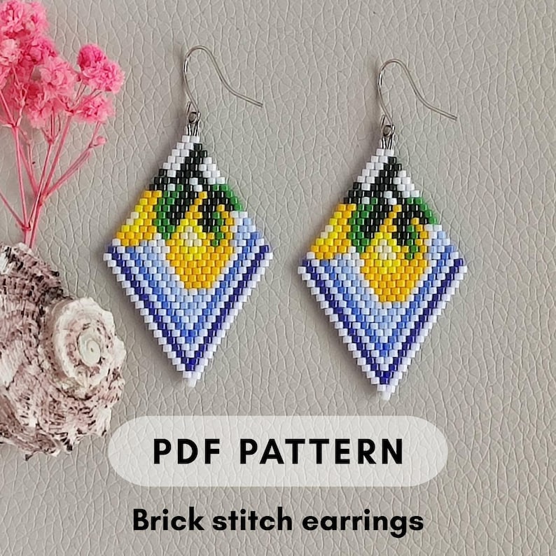 May include: A pair of diamond-shaped brick stitch earrings with a colorful design. The earrings feature a yellow and green central motif, surrounded by blue and white bands. The text "PDF PATTERN" and "Brick stitch earrings" are visible.