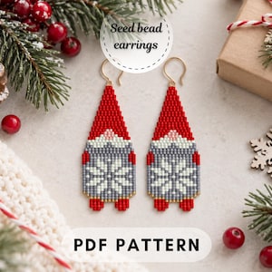 May include: A pair of seed bead earrings featuring a gnome design with a red hat, gray body, and a white snowflake pattern. The earrings have gold-toned hooks and are presented as a PDF pattern. The design includes a small pink nose and red feet.