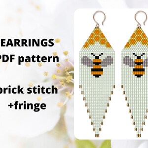 May include: A pair of white beaded earrings with a bee design and a fringe. The earrings are made with brick stitch and have a yellow honeycomb pattern at the top. The text "EARRINGS PDF pattern brick stitch +fringe" is visible in the image.