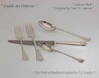 May include: Silverware set including forks, spoons, and a knife. The set is labeled "Guilde des Orfevres" and "Lamerie Shell" designed by Paul De Lamerie. The text "The Pride of Sheffield-England by C.J. Vander" is also visible.