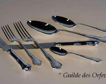 May include: An assortment of polished silverware, including forks, knives, and spoons, arranged on a light-colored surface. The silverware has ornate handles and a reflective surface. The text "Guilde des Orfevres" is visible.