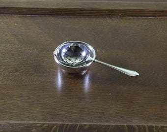 Silver Tea Strainer & Stand.