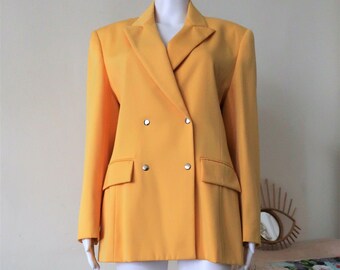 May include: A yellow double-breasted blazer with silver buttons.