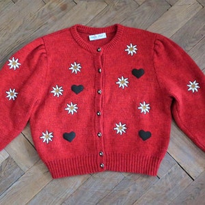 Vintage red Austrian trachten wool knit cardigan sweater with Edelweiss embroidery heart appliques and puff sleeves 1980s 80s 1990s 90s