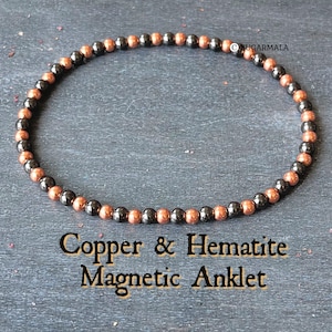 May include: Copper and hematite magnetic anklet with alternating copper and black beads.