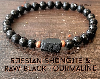 May include: A bracelet featuring 6mm black Russian Shungite beads and a central raw black tourmaline stone flanked by two copper-colored metal beads. The text on the image reads 6MM BEADS, SUGARMALA, and RUSSIAN SHUNGITE & RAW BLACK TOURMALINE.