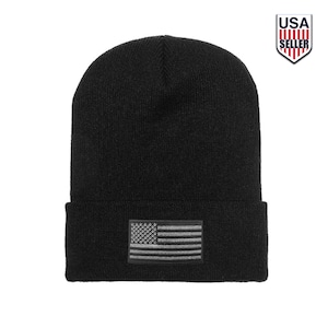 May include: Black knit beanie with a small embroidered American flag patch on the front.