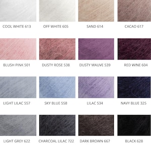 May include: A color chart displaying sixteen swatches of fuzzy, mohair-style yarn. Each square features a unique shade including Cool White 613, Off White 605, Sand 614, Cacao 617, Blush Pink 501, Dusty Rose 538, Dusty Mauve 539, Red Wine 604, Light Lilac 557, Sky Blue 558, Lilac 534, Navy Blue 325, Light Grey 622, Charcoal Lilac 722, Dark Brown 667, and Black 628.