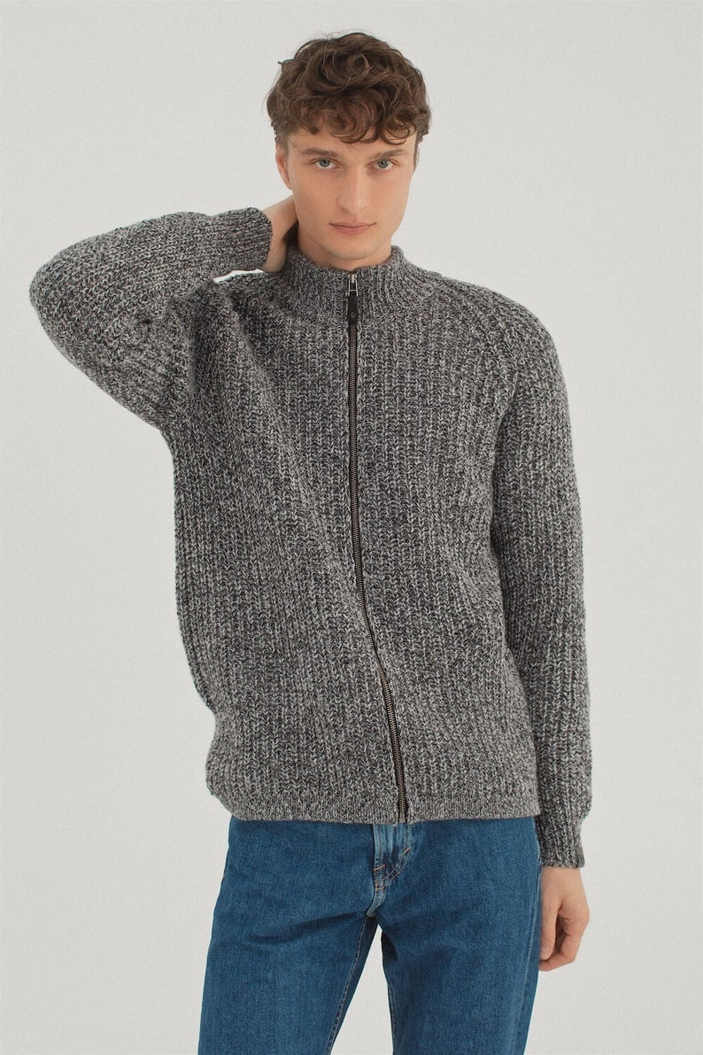 May include: A gray knitted zip-up cardigan with a textured pattern.