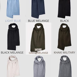 May include: A collection of nine knitted scarves in various colors including light blue, blue melange, black, black melange, moss green melange, khaki military, silver, light grey, and natural grey, each featuring a ribbed hem detail.