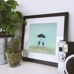 May include: A framed print of a painting depicting two bumblebees walking under a black umbrella on a light blue background.