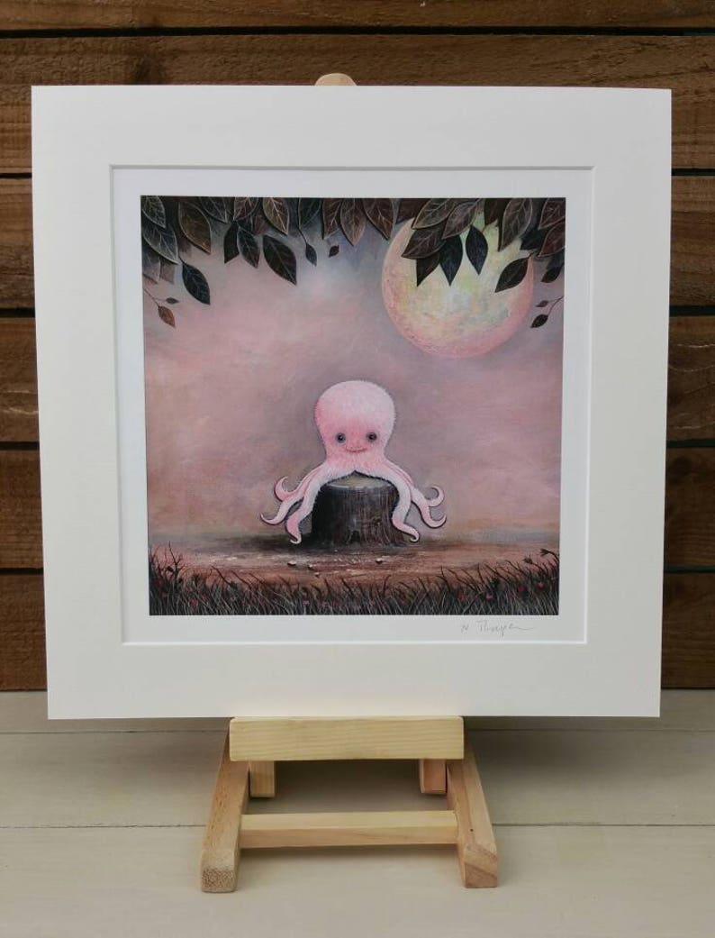 May include: A pink octopus sits on a tree stump in a whimsical forest scene. The octopus has a large, round head with big eyes and a small mouth. The background is a soft pink and purple with a large, full moon and leafy branches.