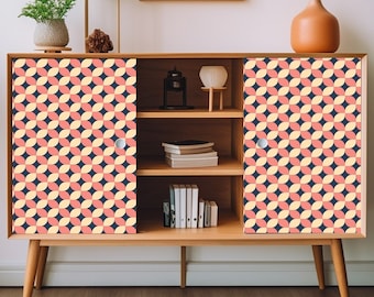 May include: A wooden cabinet with two doors featuring a geometric pattern of pink, yellow, and blue circles. The cabinet has three shelves and is sitting on a light wood floor.