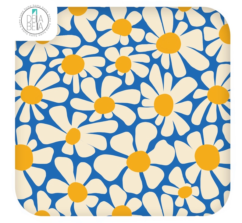 May include: A square textile featuring a repeating pattern of white daisy flowers with yellow centres against a vibrant blue background. The top left corner displays a circular logo with the text DELA BELA and the word home repeated around the edge.