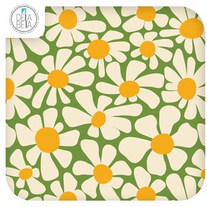 May include: A square fabric textile featuring a repeating pattern of white daisy flowers with yellow centres on a solid green background. The top left corner displays a circular logo with the text DELA BETA and the word home repeated around the edge.