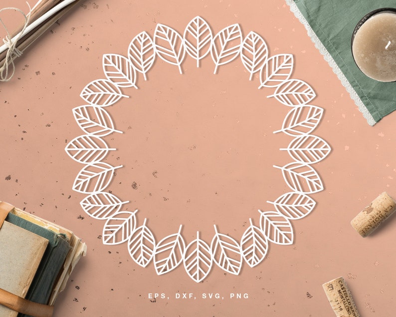 May include: A white wreath made of leaves with a circular outline. The wreath is on a light pink background.