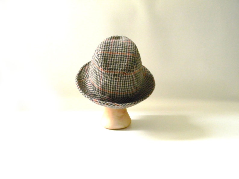 May include: A brown and gray plaid fedora hat with a red and white check pattern.
