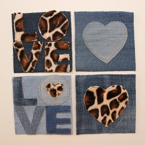 May include: Four denim squares with the word "LOVE" spelled out in brown and black leopard print fabric. The "O" is a circle and the other letters are individual. Two of the squares have a heart shape cut out of the denim and filled with leopard print fabric.