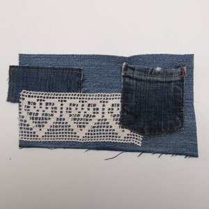 May include: A denim patchwork design with a small pocket, a rectangular patch, and a cream lace insert. The denim is mid-blue, and the lace has a detailed, openwork pattern. The patches are arranged on a white background.