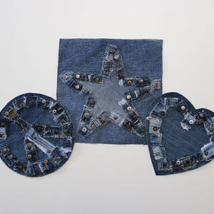 May include: Three denim patches, a star, a circle and a heart, each decorated with small denim pieces and metal studs.