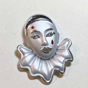 Vintage pierrot clown face brooch, silvertone metal, red enamel star and teardrop, brushed metal, silver clown pin, 1980s-90s  PP7114