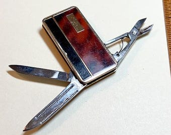 Vintage Calibri money clip and multitool, goldtone metal, brown, knife, file, scissors, wear to surface, 1980s  MI42210
