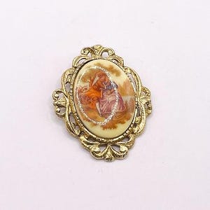 Vintage Fragonard style courting couple cameo brooch, goldtone metal, white porcelain cabochon with transfer pastoral image, 1970s  PP1031