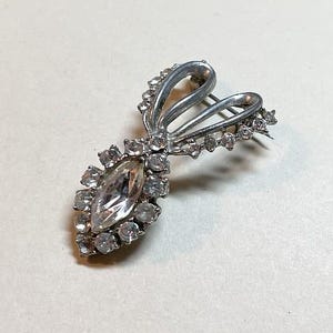 Vintage midcentury rhinestone brooch, silvertone metal, clear rhinestones, clear rhinestone pin, bow design, 1950s-60s  PR4159