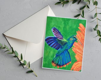 May include: A vibrant blue and green hummingbird with purple wings hovers near a bright orange flower on a green background. The hummingbird has a long, thin beak and is in mid-flight.