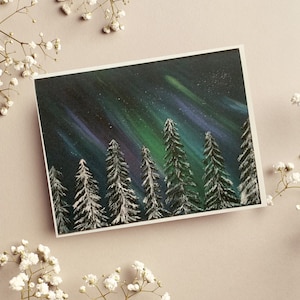 May include: A painting of a snowy forest with a green and purple aurora borealis in the sky. The trees are silhouetted against the night sky.