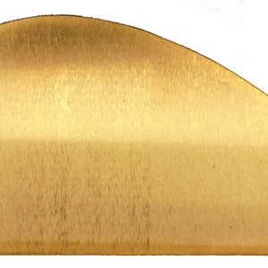 May include: A gold-colored metal half-round cabinet pull with a brushed finish.
