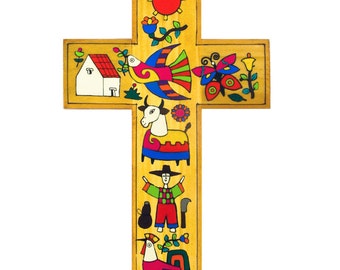 May include: A wooden cross with a colorful folk art design. The cross features a sun, a bird, a butterfly, a cow, a farmer, and a rooster. The cross is painted in bright colors, including red, yellow, blue, green, and orange.
