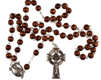 May include: A rosary with dark brown wooden beads and silver-toned metal accents. The rosary features a Celtic cross pendant and a medallion with a religious figure. The beads are strung on a silver chain.