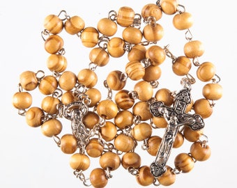 May include: A wooden rosary with brown beads and a silver crucifix.