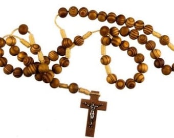 May include: A wooden rosary with brown beads and a wooden crucifix. The beads are strung on a gold cord.