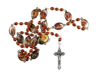 May include: A rosary with brown wooden beads and oval-shaped religious images. The rosary features a silver crucifix pendant with a detailed depiction of Jesus Christ.