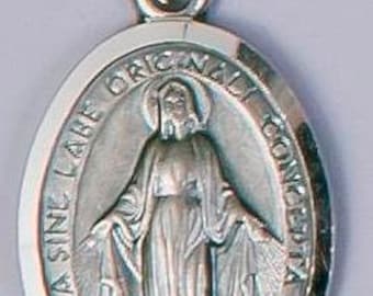 May include: Silver oval pendant featuring a depiction of the Virgin Mary with the inscription "Regina Sine Labe Originalis Concepta" around the image.