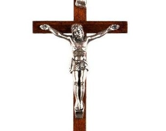 May include: A wooden crucifix with a silver Jesus figure. The cross is brown and has a simple design.