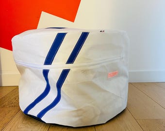 May include: White canvas storage bag with blue stripes and a zipper closure. The bag has a small pink label with text.