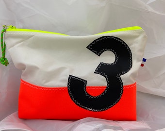 May include: A white and orange zippered pouch with a black number "3" on the front. The pouch has a neon yellow zipper and a small French flag.
