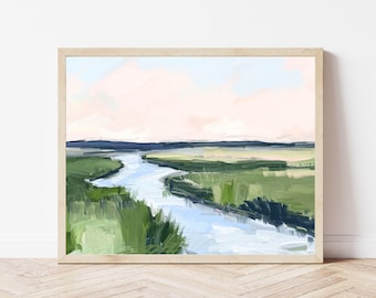 May include: An abstract landscape painting in a light wooden frame. The artwork depicts a winding river flowing through green marshland under a pink and blue sky. The brushstrokes are visible, creating a textured effect.