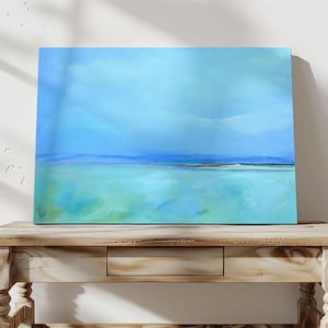 May include: Abstract painting of a seascape with a blue sky and green water. The painting is on a canvas and is framed.