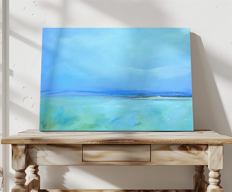 May include: Abstract painting of a seascape with a blue sky and green water. The painting is on a canvas and is framed.