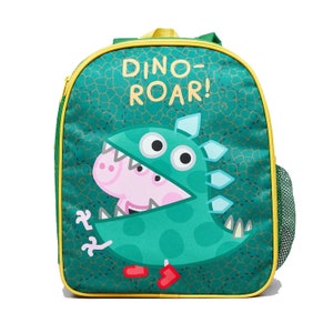 May include: A green backpack with yellow trim featuring a graphic of a pink pig character wearing a green dinosaur costume. The text DINO-ROAR! is printed in yellow at the top. The bag has a mesh side pocket and a patterned background of scales.