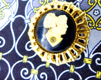 Magnetic scarf pin or brooch. Black & cream profile cameo set in an open gold frame with rhinestone detail. Silk back button. Gift packaged