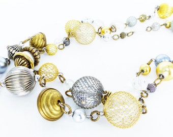 Vintage old Hollywood glam bauble extra long strand necklace. Metal mesh covered beads in silver and gold. Timeless style