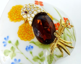 Joan Rivers beautiful amber color faceted crystal bird on branch brooch pin, set in gold with twinkle clear crystals and a red crystal eye.