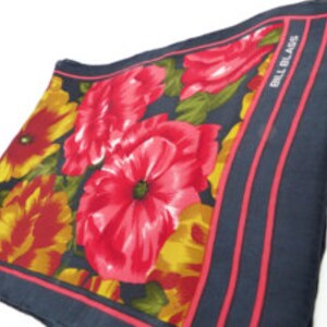 Vintage Bill Blass floral oblong silk scarf. Black background with details in sexy red and gold. Sexy hand feel silk. Comes gift packaged